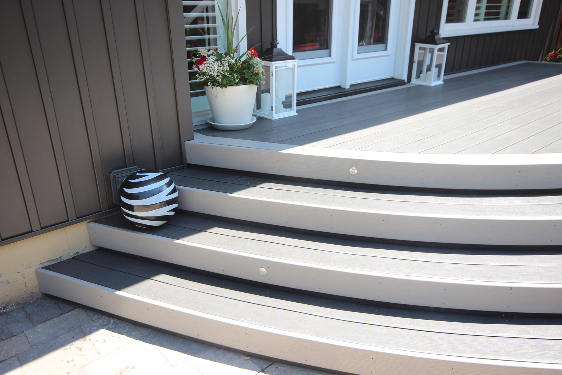 Curved deck stairs using TruNorth Clubhouse Ultra PVC decking in Clay colour with smooth, custom radius design