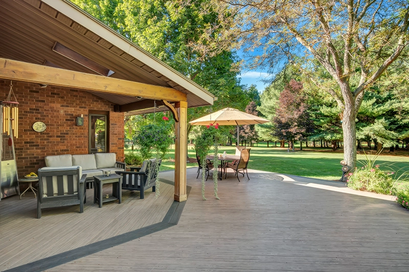 PVC decking backyard patio with covered seating area and outdoor furniture