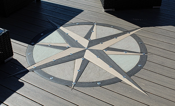 Custom TruNorth Clubhouse Ultra PVC deck with compass inlay design using Hickory and Ironwood boards