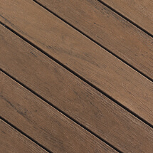 A close up view of TruNorth Decking boards in the colour Tropical Walnut
